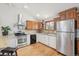 Well-lit kitchen offers stainless steel appliances, wood floors, and bright lighting at 280 Pierce St, Erie, CO 80516