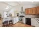 Updated kitchen with stainless steel appliances, wood cabinets, and eat-in bar seating at 280 Pierce St, Erie, CO 80516