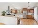 Charming kitchen features stainless appliances, wood floors, and bright lighting at 280 Pierce St, Erie, CO 80516