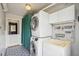 Bright laundry room features stacked washer and dryer unit, utility sink and tool storage at 280 Pierce St, Erie, CO 80516