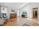 Sun-filled living room boasting hardwood floors, a large window, and a vintage jukebox at 280 Pierce St, Erie, CO 80516