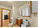 Bathroom with a wooden cabinet sink and a window overlooking the backyard at 420 Chinook Rd, Idaho Springs, CO 80452