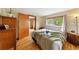 Cozy bedroom featuring hardwood floors and scenic views at 420 Chinook Rd, Idaho Springs, CO 80452