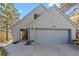 Attached two car garage and covered entryway featuring a gray color palette and peaked roof at 420 Chinook Rd, Idaho Springs, CO 80452