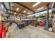 Spacious garage interior with high ceilings, storage and a variety of equipment including a boat and ATVs at 420 Chinook Rd, Idaho Springs, CO 80452