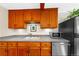Kitchen featuring custom wood cabinets, updated stainless steel appliances, and laminate countertops at 420 Chinook Rd, Idaho Springs, CO 80452