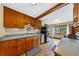 Bright kitchen featuring wood cabinets, stainless steel appliances, and hardwood floors at 420 Chinook Rd, Idaho Springs, CO 80452