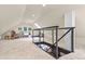 Living room featuring a modern railing overlooking the first floor and a cozy rocking chair at 420 Chinook Rd, Idaho Springs, CO 80452