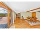 Sun-filled living room with hardwood floors, mountain views, dining table, and access to a spacious deck at 420 Chinook Rd, Idaho Springs, CO 80452