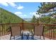 Outdoor deck offering stunning mountain views with seating for relaxing and entertaining at 420 Chinook Rd, Idaho Springs, CO 80452