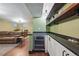 Finished basement with built in bar area, granite counters, wine fridge, and living area at 2958 E Euclid Pl, Centennial, CO 80121