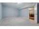 Empty bedroom with neutral-toned paint, a window and a closet for storage, and access to the recreation area at 2958 E Euclid Pl, Centennial, CO 80121