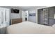 Neutral primary bedroom featuring a mounted TV, ensuite bathroom, closet and hardwood floors at 2958 E Euclid Pl, Centennial, CO 80121