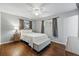 Light-filled bedroom featuring a ceiling fan, hardwood floors, and a neutral color palette at 2958 E Euclid Pl, Centennial, CO 80121