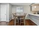 Dining area with wooden table set and view of kitchen with granite countertops at 2958 E Euclid Pl, Centennial, CO 80121