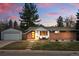Charming brick home featuring a red door, landscaped front yard and detached garage at 2958 E Euclid Pl, Centennial, CO 80121