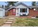 Charming home featuring a red front door and a cozy front porch with patio furniture at 2958 E Euclid Pl, Centennial, CO 80121