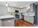 This kitchen features wood floors, stainless steel appliances and stone countertops and backsplash at 2958 E Euclid Pl, Centennial, CO 80121