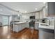 The open kitchen flows into the dining area, featuring white cabinets, countertops, and stainless appliances at 2958 E Euclid Pl, Centennial, CO 80121