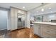 Open concept kitchen with white countertops, stainless steel fridge, and wood floors, with a view into the living room at 2958 E Euclid Pl, Centennial, CO 80121