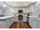 Kitchen featuring white cabinets, stainless steel appliances, light countertops, and wood floors at 2958 E Euclid Pl, Centennial, CO 80121