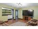 Cozy living room with hardwood floors, a wet bar, and a large screen television for entertainment at 2958 E Euclid Pl, Centennial, CO 80121