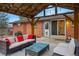 Outdoor patio with stylish wicker seating and a wood pergola, perfect for relaxing or entertaining at 2958 E Euclid Pl, Centennial, CO 80121