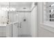 Modern bathroom featuring a glass-enclosed shower with beautiful tile work and updated fixtures at 9861 E Ohio Ave, Denver, CO 80247