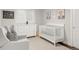 Bright Bedroom featuring a crib, dresser, and comfortable seating area at 9861 E Ohio Ave, Denver, CO 80247