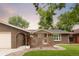 Charming brick home featuring a quaint front patio and lush, well-manicured lawn at 9861 E Ohio Ave, Denver, CO 80247