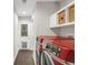 Functional laundry room featuring a front loading washer and dryer, custom storage and outside access at 9861 E Ohio Ave, Denver, CO 80247