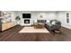 Cozy living room with a modern fireplace, mounted TV, and sleek hardwood floors at 9861 E Ohio Ave, Denver, CO 80247