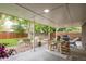 Inviting covered patio with seating, dining area, grill, and lush backyard, ideal for outdoor entertaining at 9861 E Ohio Ave, Denver, CO 80247