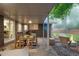 Covered brick patio has an outdoor dining area and fire pit, great for relaxing or entertaining at 9861 E Ohio Ave, Denver, CO 80247