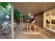 Covered patio with dining and lounge area offers views of the backyard, perfect for outdoor living at 9861 E Ohio Ave, Denver, CO 80247