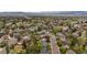 Aerial view of a residential neighborhood showing homes, trees, and mountain backdrop at 7282 S Vance St, Littleton, CO 80128