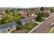 Aerial view of neighborhood, showing tree lined street, nearby buildings, and mountain view at 7282 S Vance St, Littleton, CO 80128