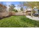 Well-maintained backyard with lush green lawn and outdoor patio area with grill and dining at 7282 S Vance St, Littleton, CO 80128