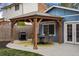 Cozy backyard patio featuring a gazebo, dining set, grill, and a well-manicured lawn at 7282 S Vance St, Littleton, CO 80128