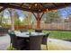 Outdoor patio with a covered dining area and manicured green space at 7282 S Vance St, Littleton, CO 80128