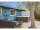 Backyard patio area with hot tub and comfortable outdoor seating, perfect for relaxation at 7282 S Vance St, Littleton, CO 80128