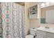 Bathroom featuring a shower with floral curtains and ample shelving at 7282 S Vance St, Littleton, CO 80128