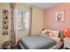 Cozy bedroom featuring a neutral palette, a window, and ample natural light at 7282 S Vance St, Littleton, CO 80128
