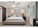 This main bedroom features a ceiling fan, a window, and stylish furnishings at 7282 S Vance St, Littleton, CO 80128