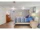 Comfortable bedroom with a wooden bed frame, stylish lamps, and a neutral color scheme at 7282 S Vance St, Littleton, CO 80128