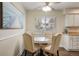 Bright dining area features a ceiling fan and a table set for four near a window at 7282 S Vance St, Littleton, CO 80128