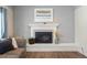 White brick fireplace provides a cozy focal point in this inviting living space at 7282 S Vance St, Littleton, CO 80128
