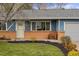 Charming home exterior with well-kept front yard and a cozy front porch bench at 7282 S Vance St, Littleton, CO 80128