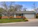 Charming single-story home with a well-manicured front yard and a two car garage at 7282 S Vance St, Littleton, CO 80128