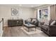Cozy living room featuring hardwood floors and comfortable seating for a relaxing atmosphere at 7282 S Vance St, Littleton, CO 80128
